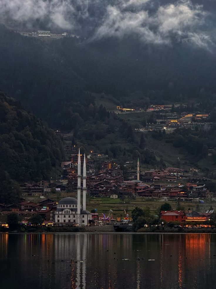 Uzungöl at dusk — mosque and village reflected in the lake beneath misty mountains